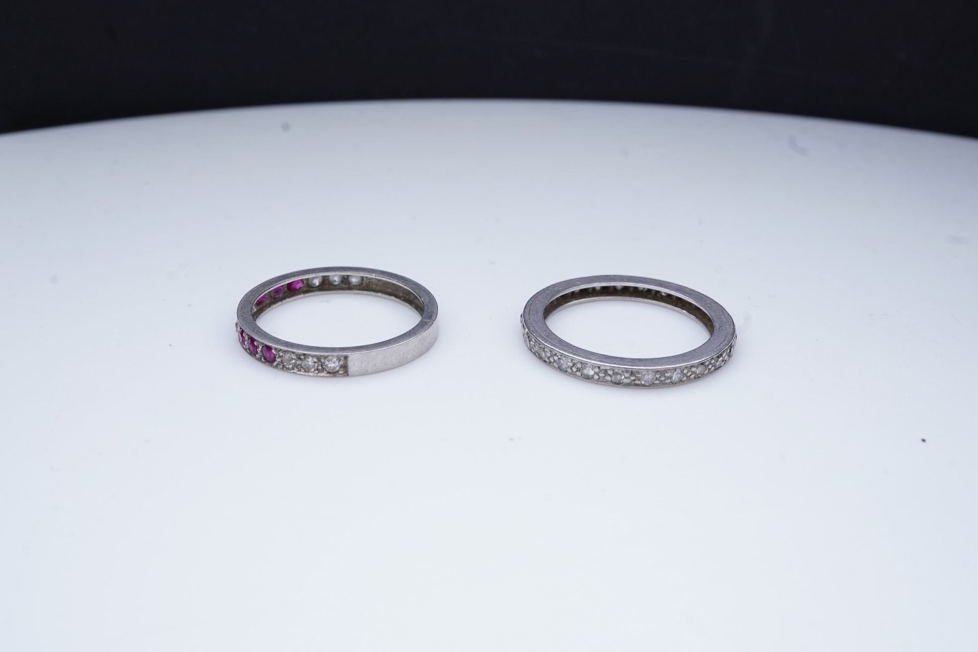 A diamond eternity ring and a ruby and diamond half eternity ring, mid 20th century